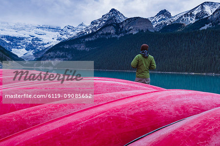 Traveler at the canoe house of Lake Louise, Banff National Park, UNESCO World Heritage Site, Canadian Rockies, Alberta, Canada, North America