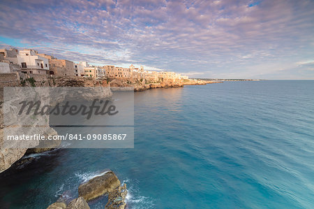 Sunrise on the turquoise sea framed by old town perched on the rocks, Polignano a Mare, Province of Bari, Apulia, Italy, Europe