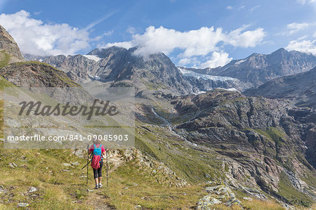 Hiker on path Sentiero Glaciologico with Fellaria Glacier in the background, Malenco Valley, Valtellina, Lombardy, Italy, Europe