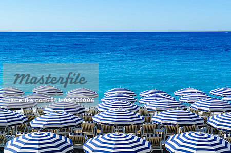 Blue and white beach parasols, Nice, Alpes Maritimes, Cote d'Azur, Provence, France, Mediterranean, Europe