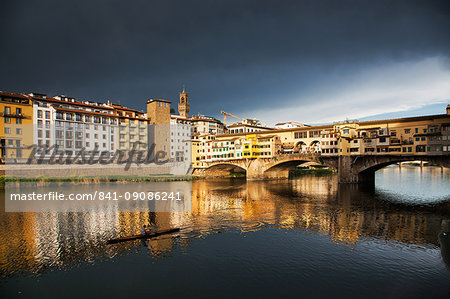 Ponte Vecchio reflected in the Arno River against a dark blue stormy sky, Florence, UNESCO World Heritage Site, Tuscany, Italy, Europe