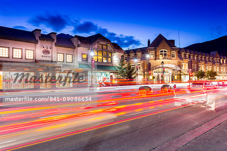 Trail lights and shops on Banff Avenue at dusk, Banff, Banff National Park, Alberta, Canada, North America