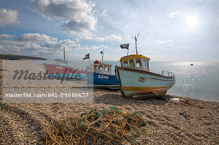 Three small fishing boats pulled up on shingle beach, Beer, Devon, England, United Kingdom, Europe Three small fishing boats pulled up on shingle beach, Beer, Devon, England, United Kingdom, Europe