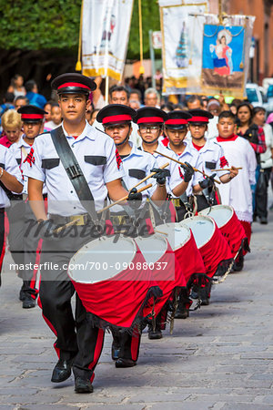Marching band and religous procession in the St Michael Archangel Festival parade in San Miguel de Allende, Mexico