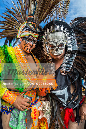 Portrait of two, male indigenous tribal dancers in costumes looking at the camera at the St Michael Archangel Festival parade in San Miguel de Allende, Mexico