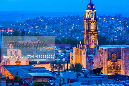 The 18 century Church of San Francisco (formerly the Convent of San Antonio) with the prominent bell tower and overview of city at dusk in San Miguel de Allende, Mexico