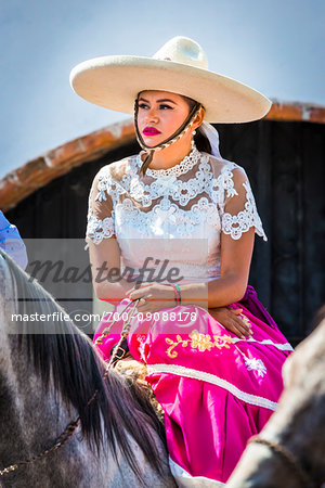 Portrait of Mexican woman in traditional clothing on horse-back in the Independence Day parade in San Miguel de Allende, Mexico