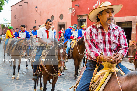 Men riding in historic horseback parade celebrating Mexican Independence Day in San Miguel de Allende, Mexico Men riding in historic horseback parade celebrating Mexican Independence Day in San Miguel de Allende, Mexico