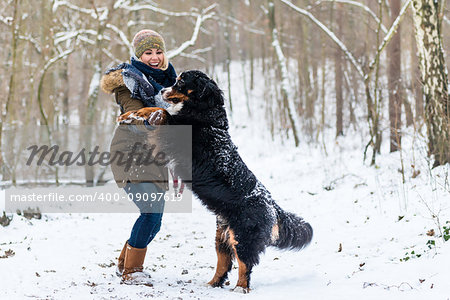Big Dog hugging his mom on a winter day with snow