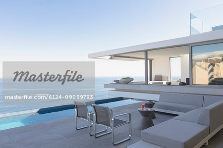 Modern, luxury home showcase exterior patio with lap pool and ocean view