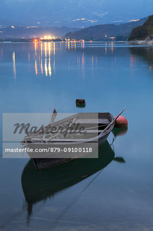 Boat at Santa Croce Lake, Alpago, Belluno Prealps, Veneto, Italy.