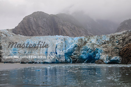 Blue ice face and floating ice, Sawyer Glacier and mountains, misty conditions, Stikine Icefield, Tracy Arm Fjord, Alaska, United States of America, North America