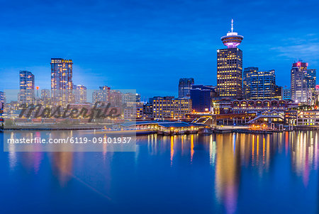 City skyline including Vancouver Lookout Tower as viewed from Canada Place at dusk, Vancouver, British Columbia, Canada, North America