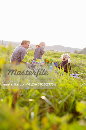 Man having picnic with his daughters in Bergum, Sweden