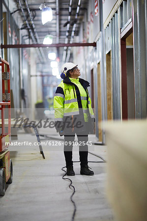 Woman in protective clothing standing and looking away