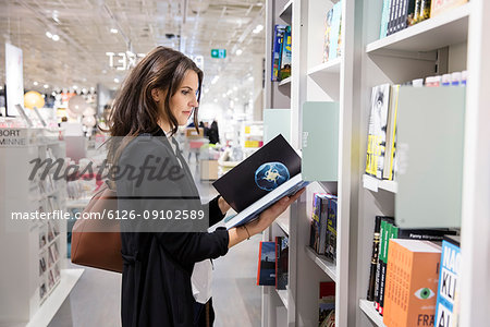 Woman choosing books in store