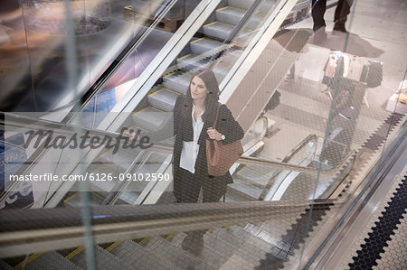 Woman on escalator in shopping center