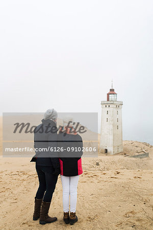 Mother and daughter looking at Rubjerg Knude fyr lighthouse