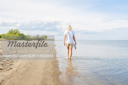 Woman walking on beach at lakeside