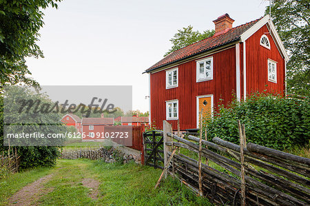 Traditional wooden fence and brown house