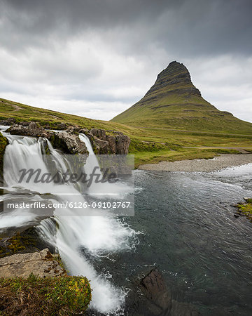 Kirkjufellsfoss waterfall and Kirkjufell mountain in Iceland