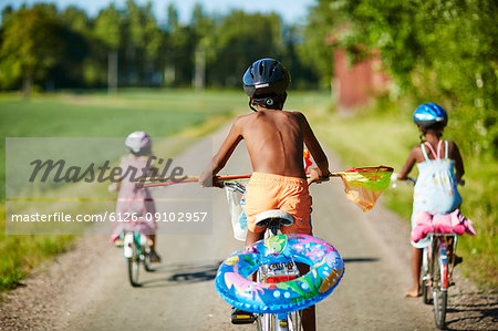 Children cycling on a rural road in Gullspang, Sweden