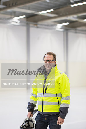 Mature man wearing protective workwear in industrial hall