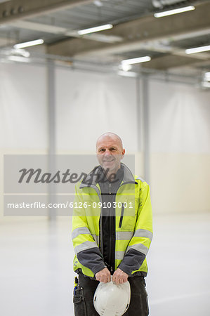 Mature man wearing protective workwear in industrial hall