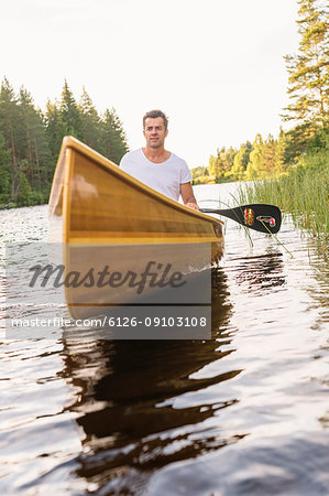 Man paddling on lake