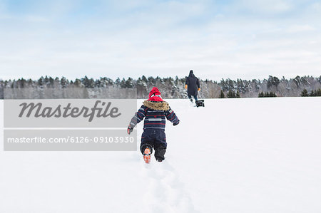 Rear view of child playing in snow