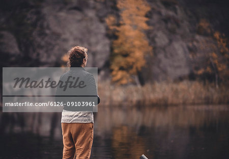 Rear view of woman at lake in Flaten, Sweden