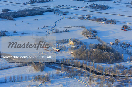 Church by snow covered fields in Narke, Sweden