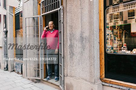 Man on phone at storefront in Sweden