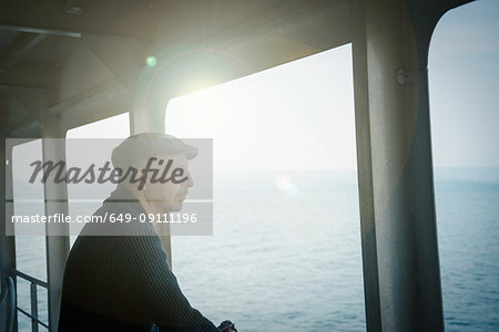 Man on ferry looking away out of window