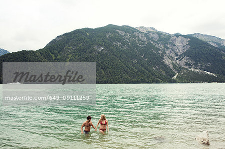 Couple waist deep in water, Achensee, Innsbruck, Tirol, Austria, Europe