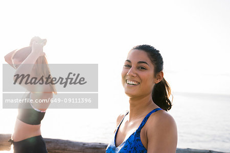 Portrait of two young women training on beach
