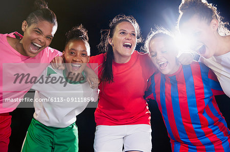 Portrait enthusiastic, confident young female soccer team bonding and cheering in huddle
