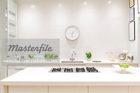 White, modern luxury home showcase interior kitchen with clock