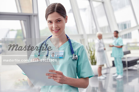 Portrait smiling, confident female nurse with clipboard in hospital