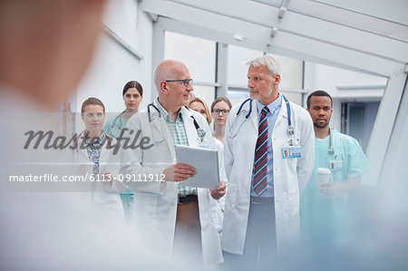 Doctors and nurses walking in hospital corridor