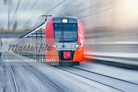 Modern high-speed train moves fast at winter evening time.