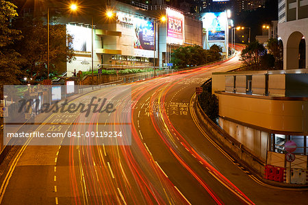 Car light trails on a busy road in Central, Hong Kong Island by night, Hong Kong, China, Asia