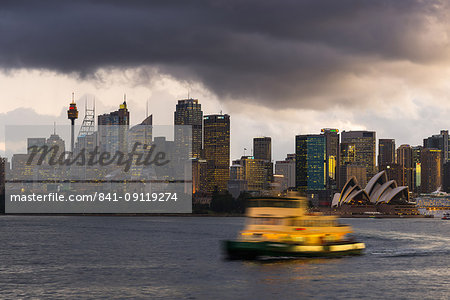 A ferry in Sydney Harbour at dusk with the Opera House and city skyline, Sydney, New South Wales, Australia, Pacific