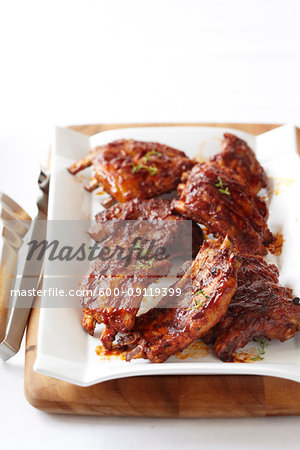 Platter of pork ribs with bbq sauce and thyme