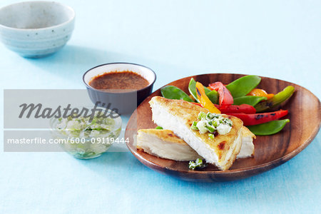 Crispy fried tofu with green onion salsa served with sauteed snow peas and peppers and a dipping sauce