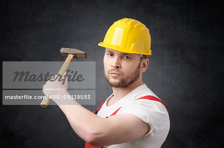 Angry construction worker with a hammer in his hand