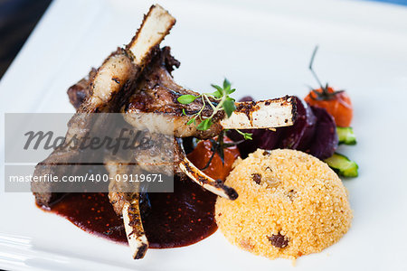 Grilled lamb carre with warm couscous salad, roasted vegetables, Dijon mustard and red wine sauce