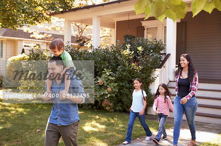 Father Gives Son Ride On Shoulders As Family Leave House