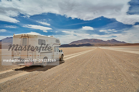 Recreational vehicle, travelling across landscape, rear view, Villa Alota, Potosi, Bolivia, South America