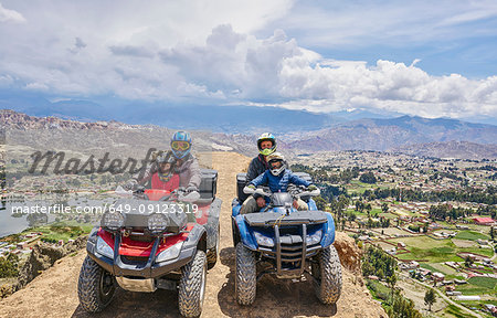 Family on top of mountain, using quad bikes, La Paz, Bolivia, South America